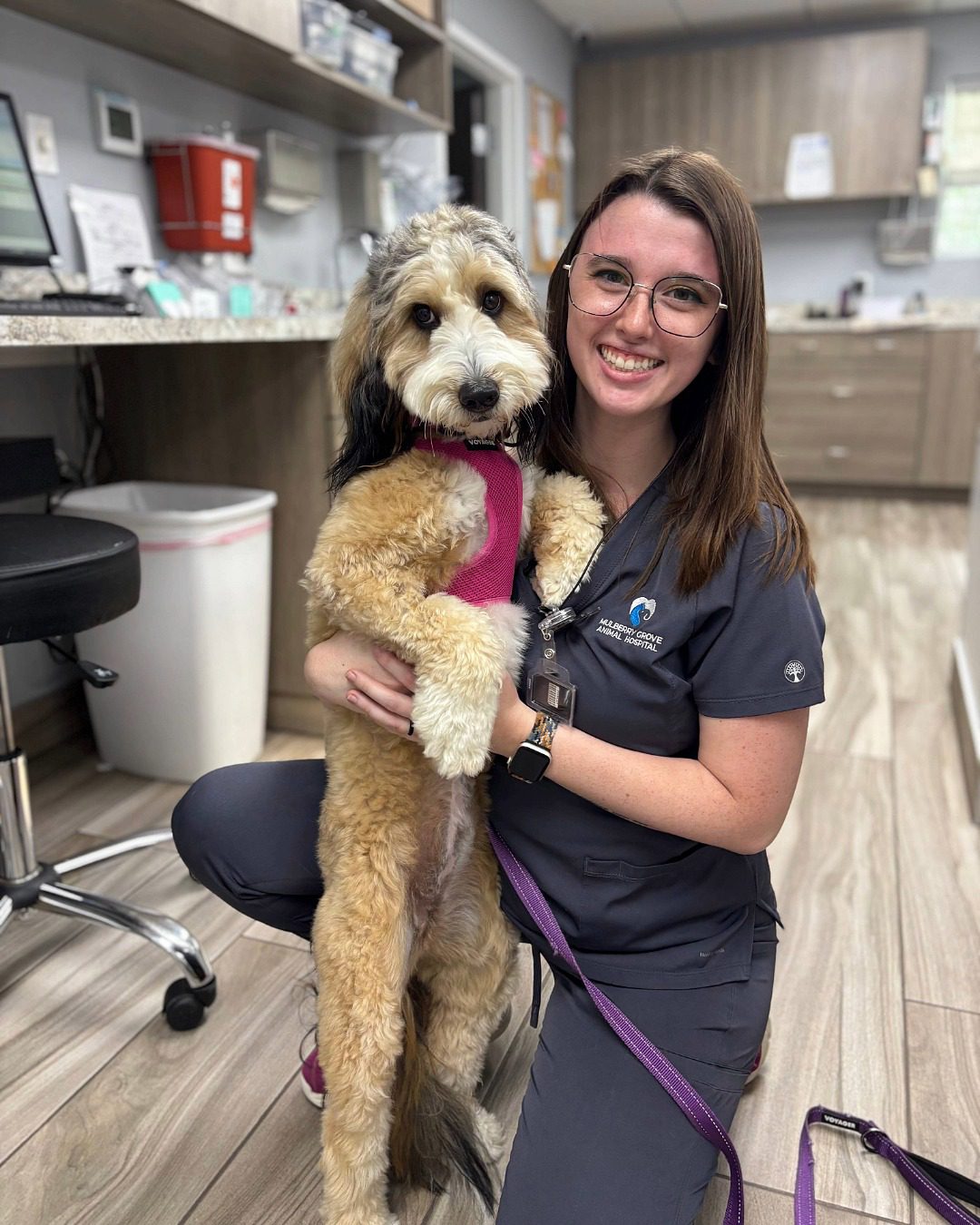 Female Staff Member Posing With Dog